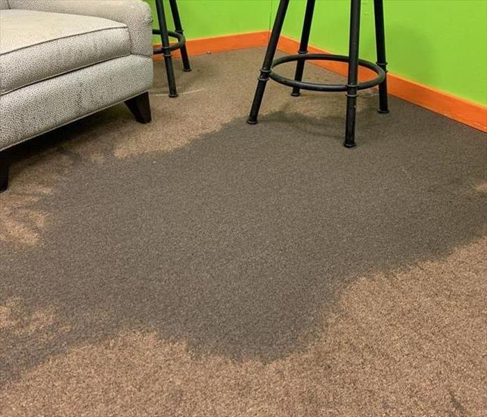 Water covering carpeted floor